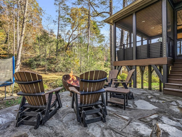 268 Firefly Cv, Lake Lure, NC 28746 - view of patio / terrace featuring a trampoline, a fire pit, stairs, and a sunroom