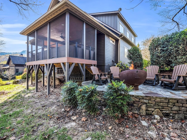 back of property with a patio area and a sunroom