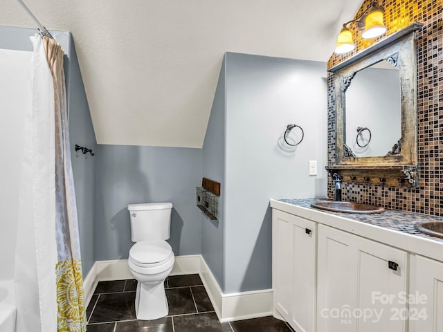 full bathroom featuring tile patterned floors, vaulted ceiling, toilet, decorative backsplash, and vanity