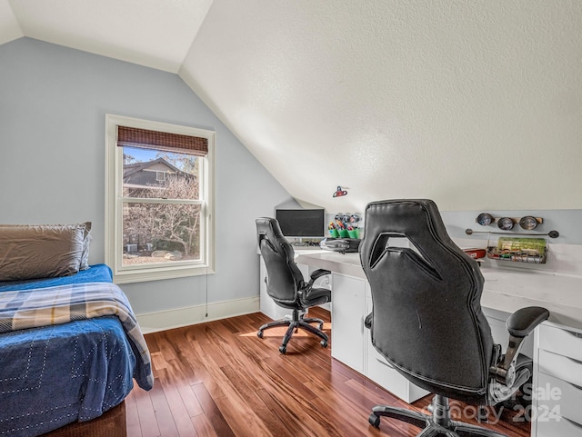 office space with a textured ceiling, lofted ceiling, and hardwood / wood-style flooring