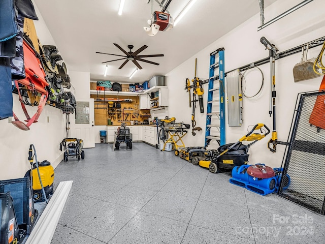 garage featuring a workshop area, ceiling fan, and a garage door opener