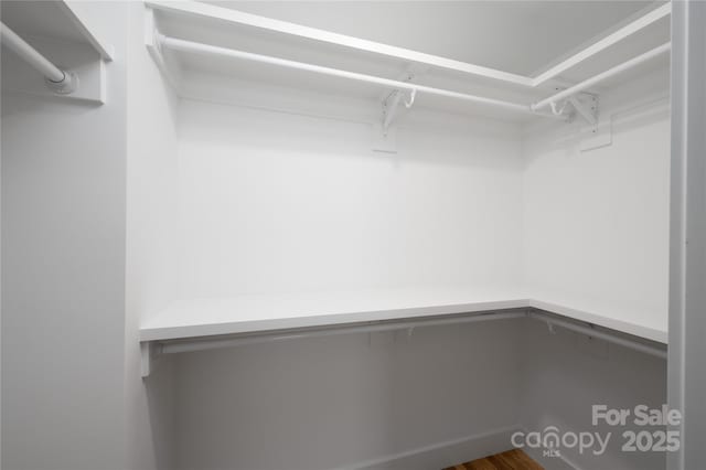 spacious closet featuring built in desk