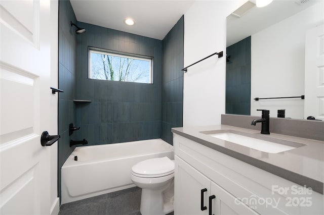 full bathroom with toilet, vanity, and tiled shower / bath