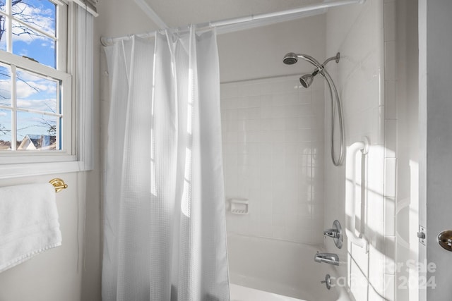 bathroom featuring plenty of natural light and shower / bath combination with curtain