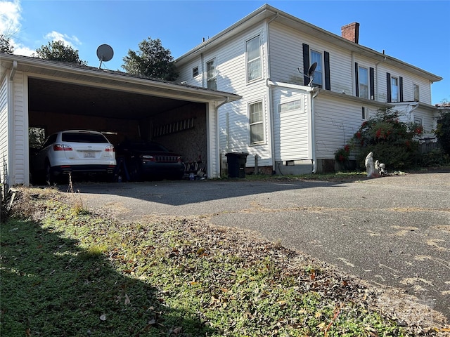 view of side of property featuring a carport