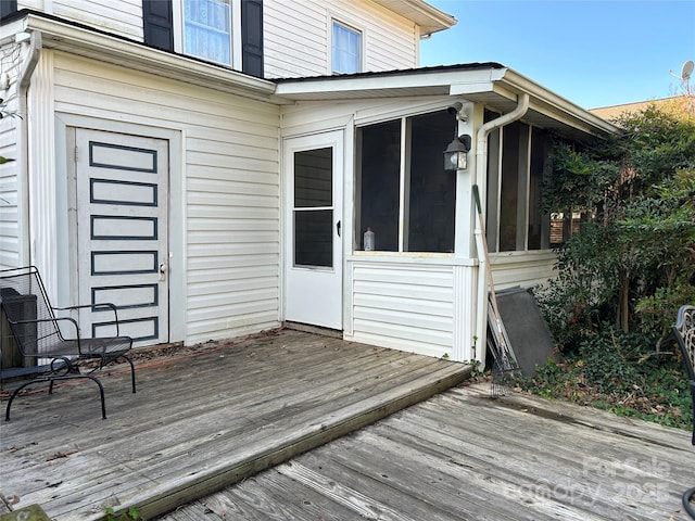 wooden deck featuring a sunroom