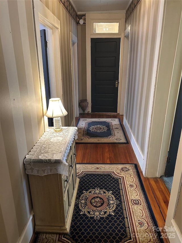 hallway featuring dark hardwood / wood-style flooring and ornamental molding