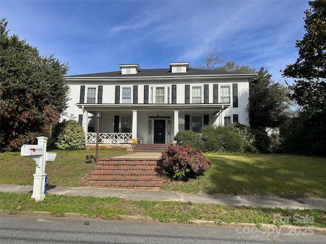 view of front of property with a porch and a front yard