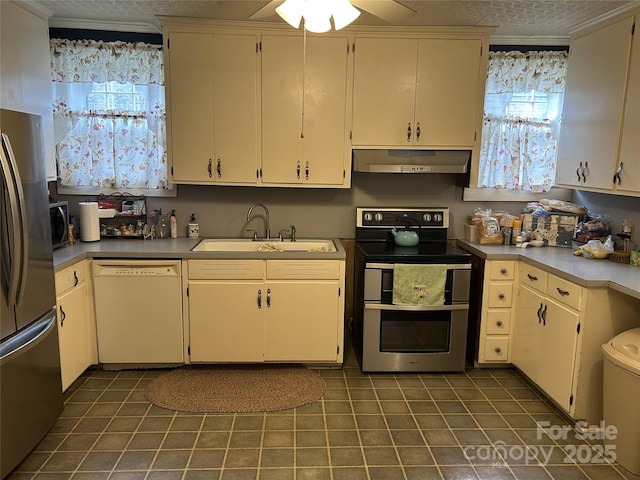 kitchen featuring sink, white cabinetry, ornamental molding, ceiling fan, and stainless steel appliances