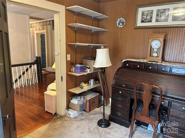 office area with wooden walls and carpet