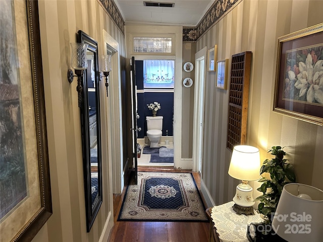 hall featuring dark wood-type flooring and ornamental molding