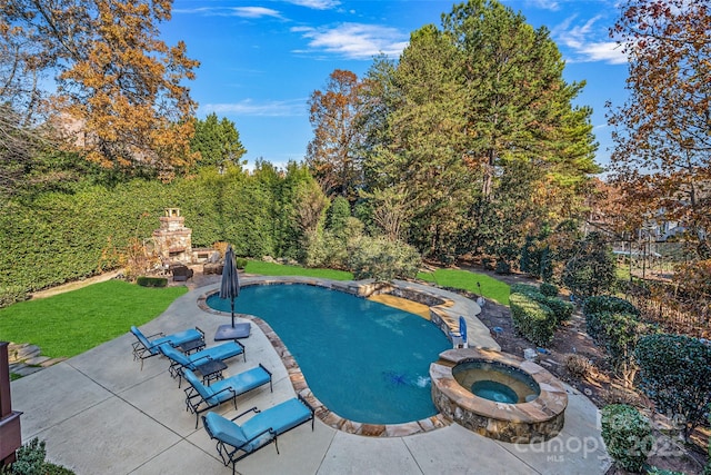 view of swimming pool featuring an outdoor stone fireplace and a patio area