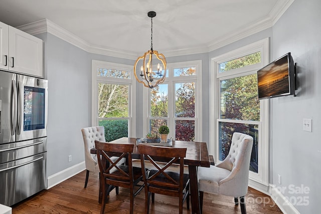 dining area with dark hardwood / wood-style flooring, ornamental molding, and a notable chandelier