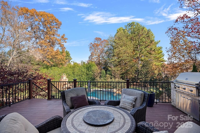 deck with a fenced in pool and a grill