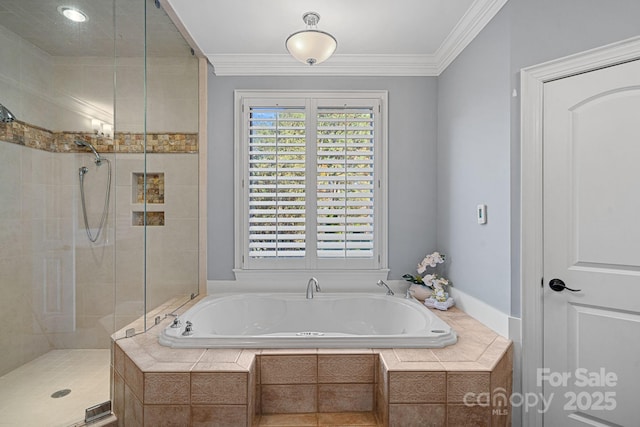 bathroom with ornamental molding and shower with separate bathtub