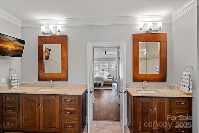 bathroom featuring tile patterned flooring, vanity, ornamental molding, and a notable chandelier