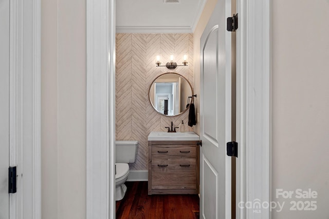 bathroom featuring hardwood / wood-style floors, vanity, toilet, and ornamental molding