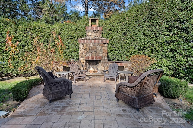 view of patio with an outdoor stone fireplace