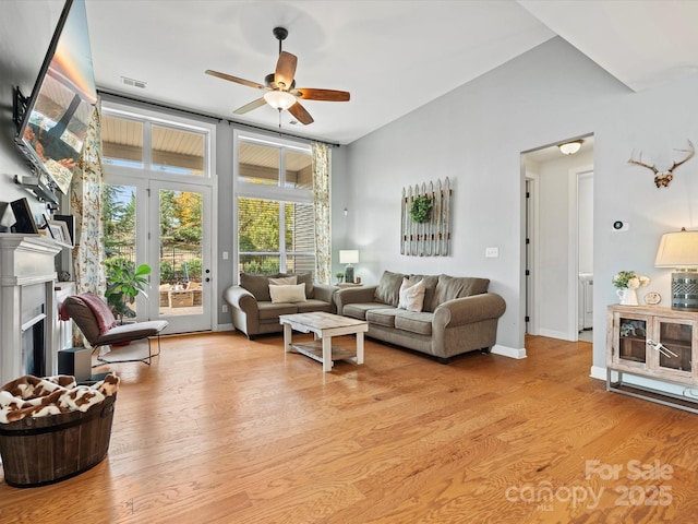 living room with light wood-type flooring and ceiling fan