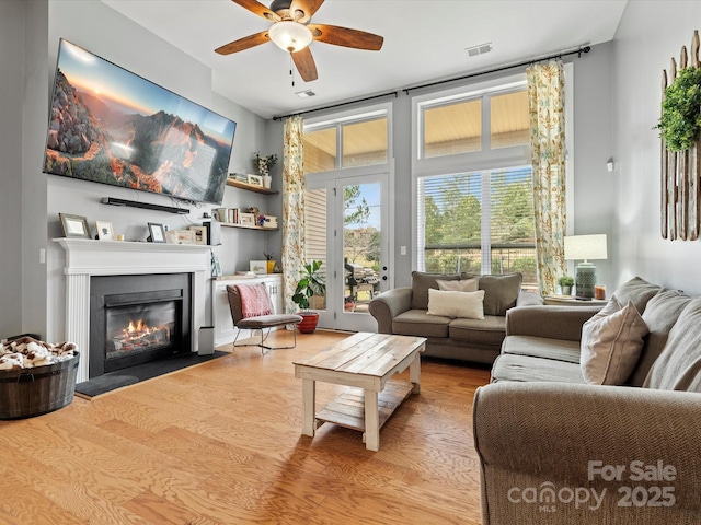 living room featuring ceiling fan and light wood-type flooring