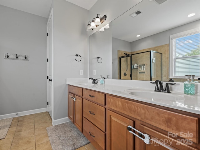 bathroom with tile patterned floors, vanity, and walk in shower