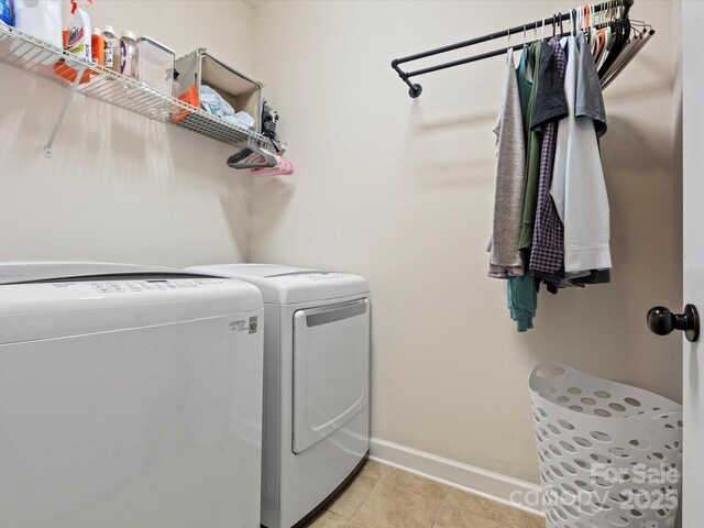 washroom with washer and clothes dryer and light tile patterned flooring