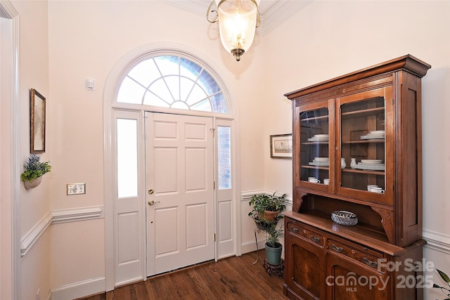 entryway with dark hardwood / wood-style flooring and ornamental molding