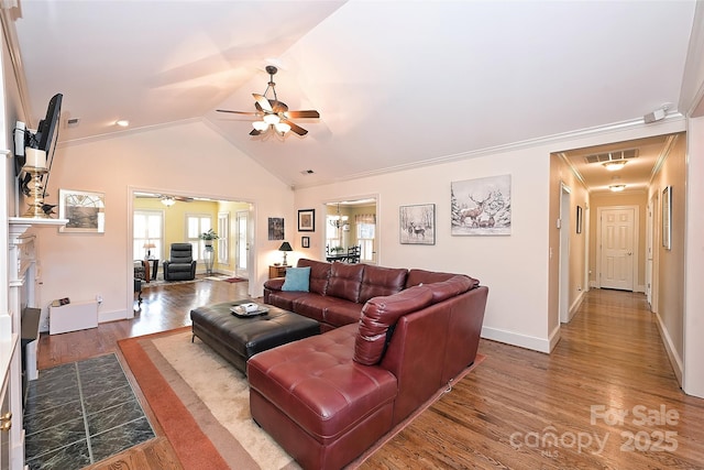 living room with ceiling fan, wood-type flooring, crown molding, and vaulted ceiling