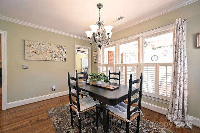 dining space with dark hardwood / wood-style flooring, ceiling fan with notable chandelier, and ornamental molding