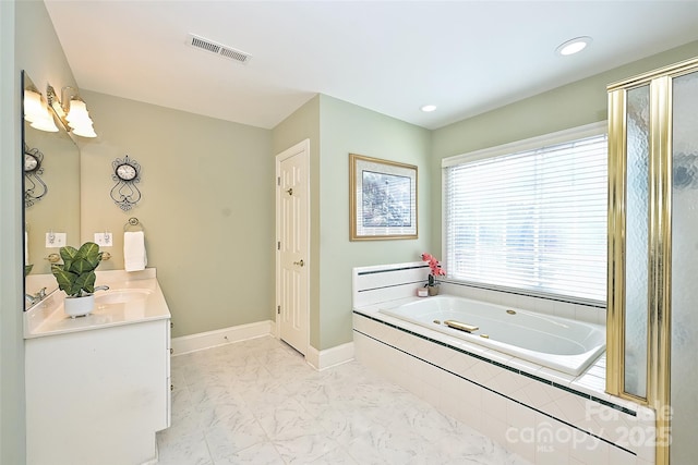 bathroom featuring vanity and shower with separate bathtub