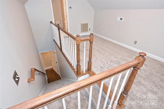 stairs with lofted ceiling and carpet