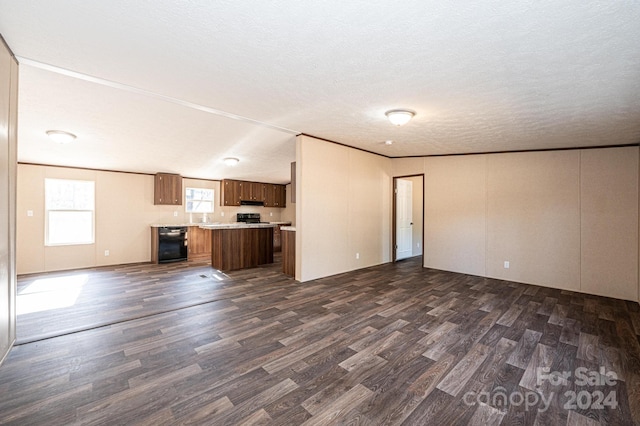 unfurnished living room featuring a textured ceiling and dark wood-type flooring