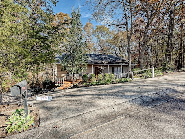 single story home featuring covered porch