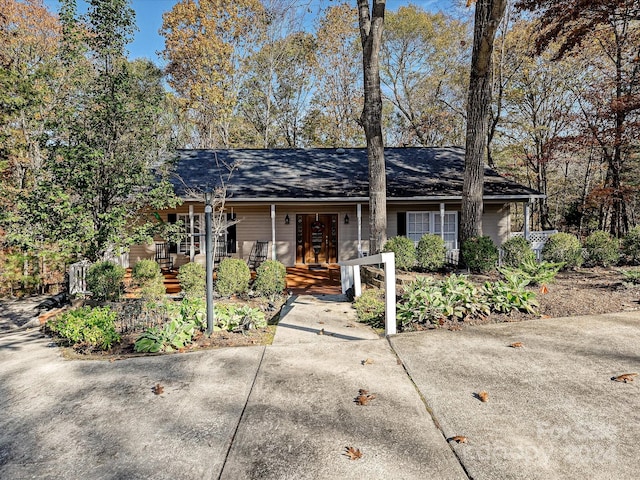 ranch-style home featuring french doors and covered porch