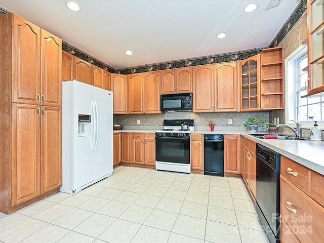 kitchen featuring backsplash, a textured ceiling, sink, black appliances, and light tile patterned floors