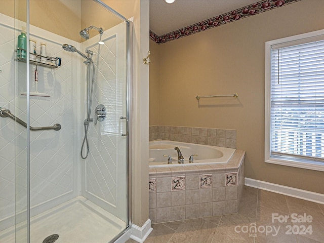 bathroom featuring tile patterned floors and independent shower and bath