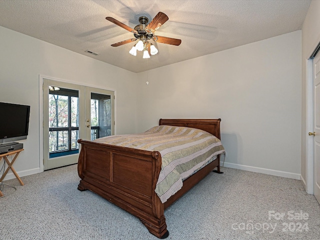 carpeted bedroom with ceiling fan, a textured ceiling, access to outside, and french doors