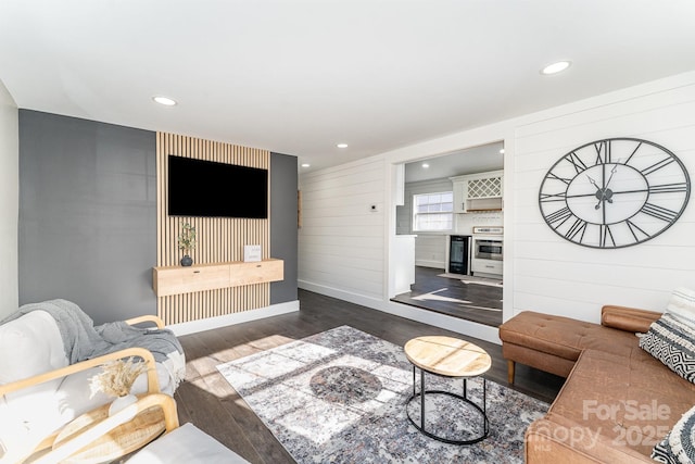 living room with wood walls and dark hardwood / wood-style flooring