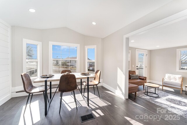 dining area with dark hardwood / wood-style flooring and lofted ceiling