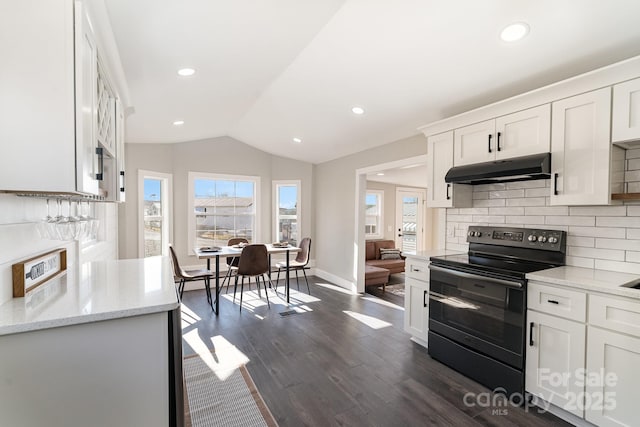 kitchen featuring light stone countertops, backsplash, electric range, white cabinetry, and lofted ceiling