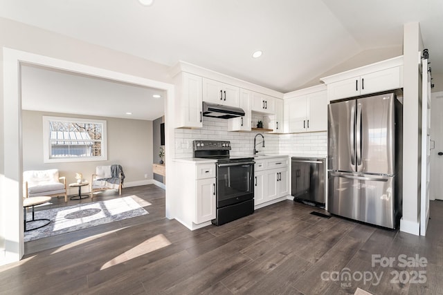 kitchen with stainless steel appliances, white cabinetry, lofted ceiling, and sink