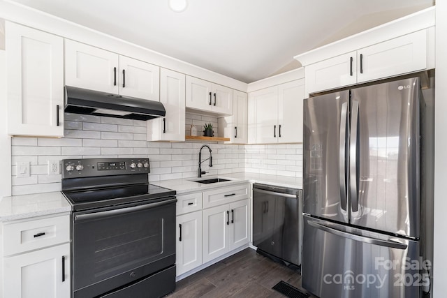 kitchen with white cabinetry, sink, light stone countertops, and appliances with stainless steel finishes