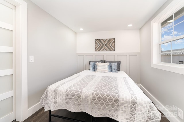 bedroom with dark hardwood / wood-style floors