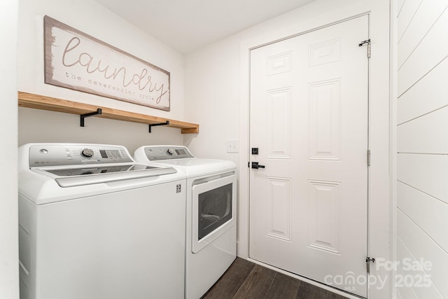 clothes washing area with washer and dryer and dark hardwood / wood-style floors