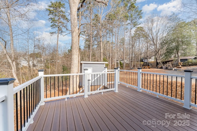 wooden terrace featuring a storage shed