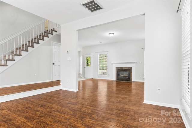 unfurnished living room with wood-type flooring