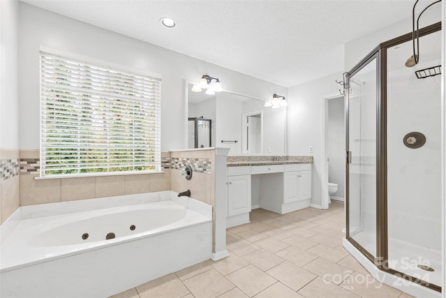 full bathroom with tile patterned floors, a textured ceiling, shower with separate bathtub, toilet, and vanity