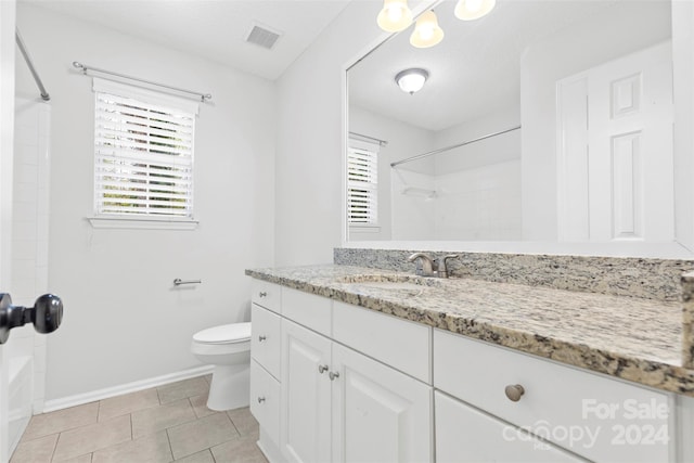 bathroom featuring tile patterned floors, vanity, a textured ceiling, and toilet