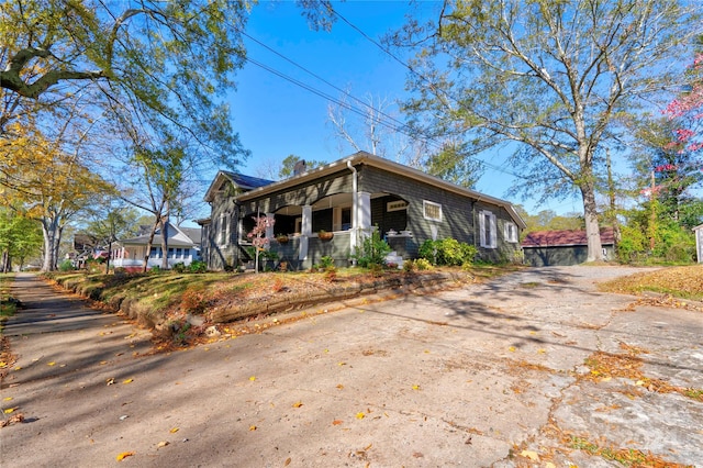 view of side of property with covered porch