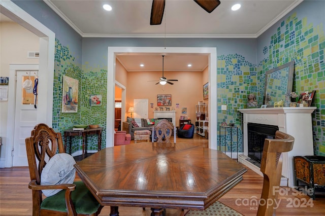 dining space featuring hardwood / wood-style flooring and ornamental molding